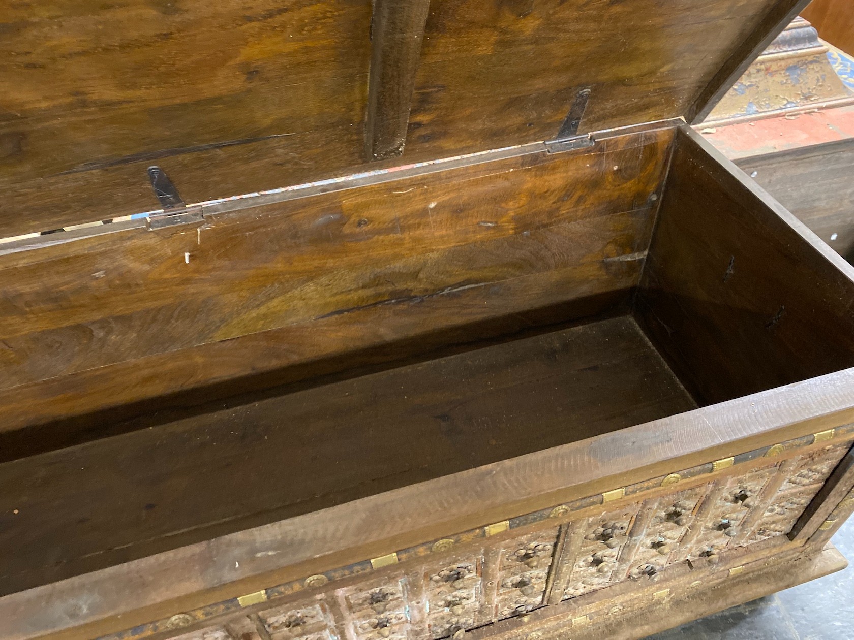 A South Asian brass mounted carved hardwood coffer, length 145cm, depth 55cm, height 50cm